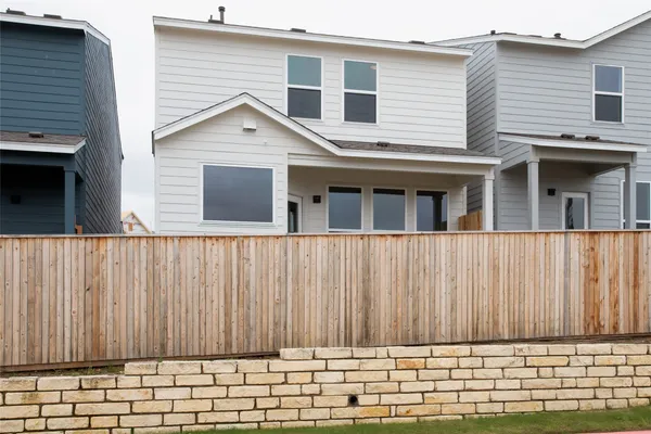 a view of a backyard with stairs and a wooden fence