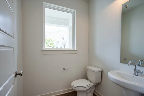 a white toilet sitting next to a bathroom sink