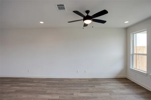 an empty room with closet and windows