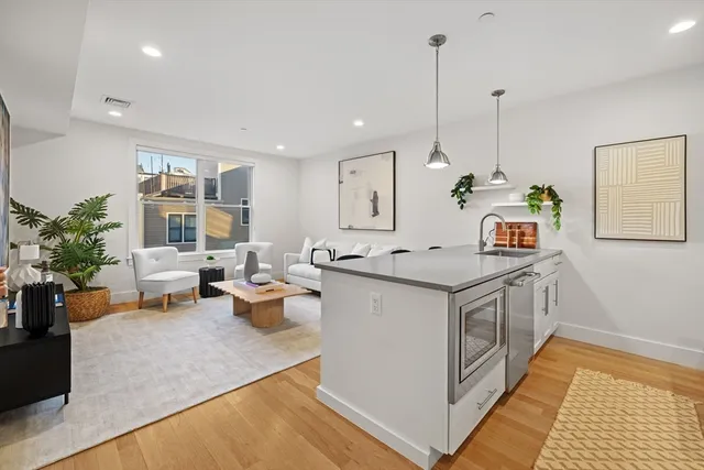 a kitchen with a stove and a wooden floor