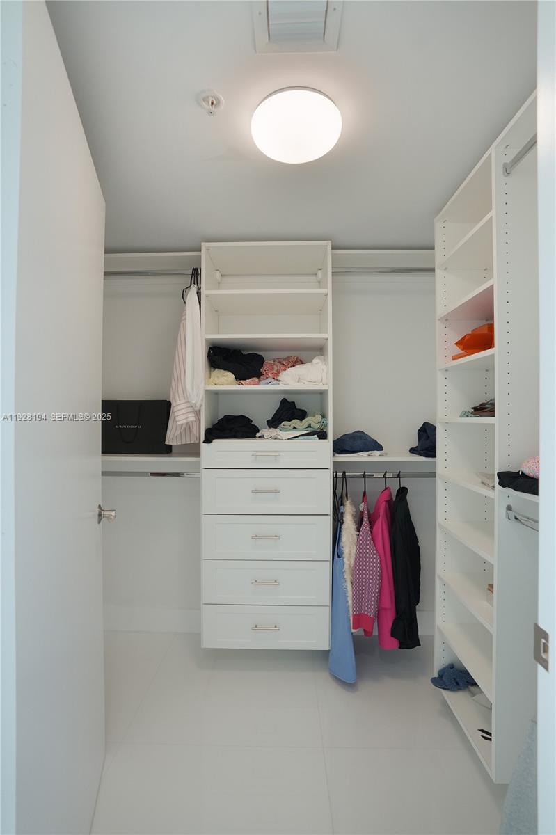 250 Sunny Isles Boulevard, Unit TH207 Sunny Isles Beach, FL 33160 - Photo 15 of 33 a view of walk in closet with clothes and shoes