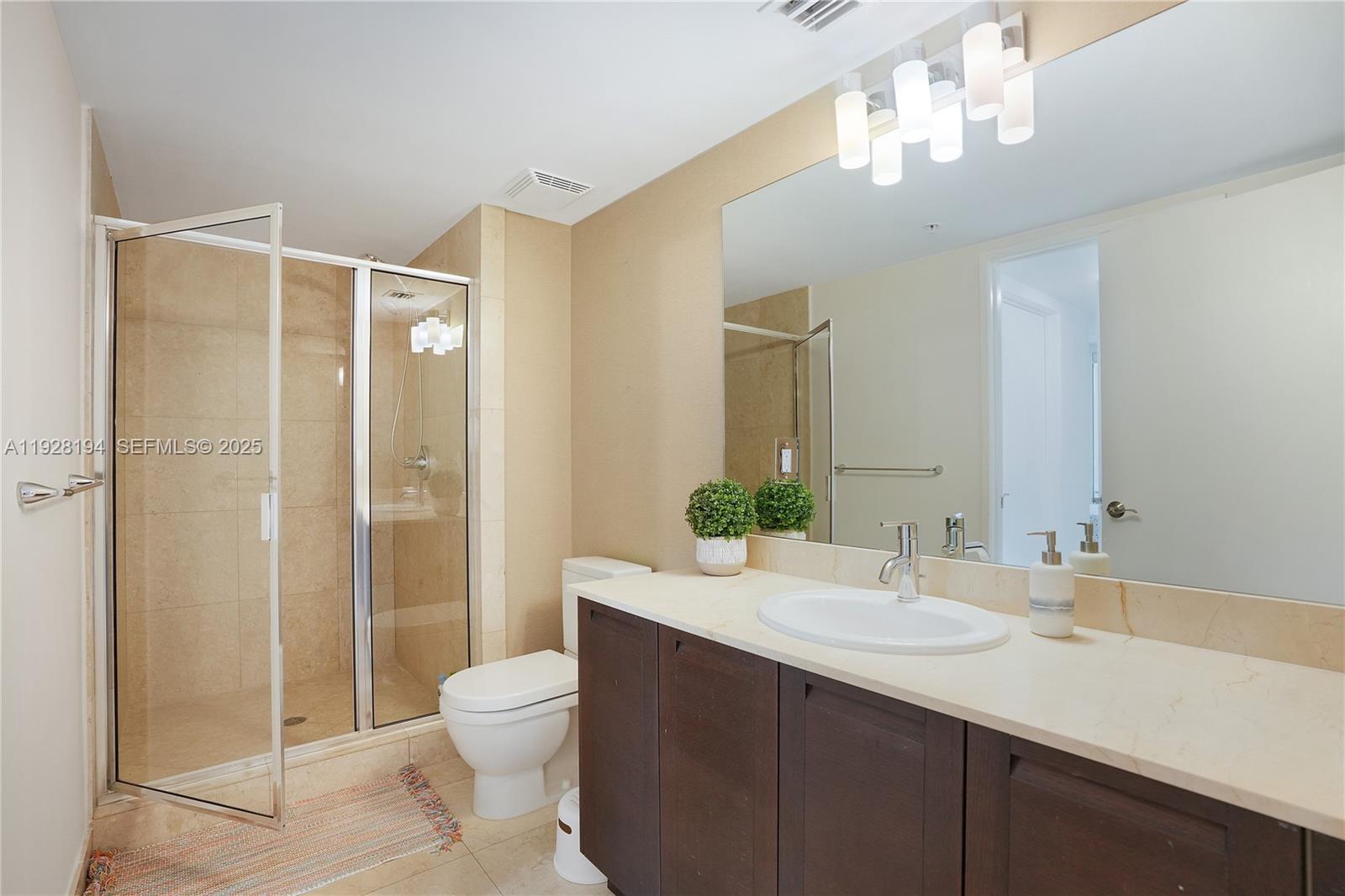 250 Sunny Isles Boulevard, Unit TH207 Sunny Isles Beach, FL 33160 - Photo 22 of 33 a bathroom with a sink a toilet and shower