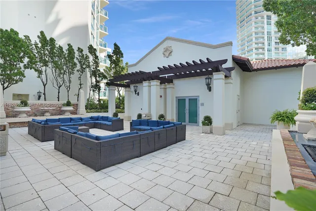 a view of a house with backyard and sitting area