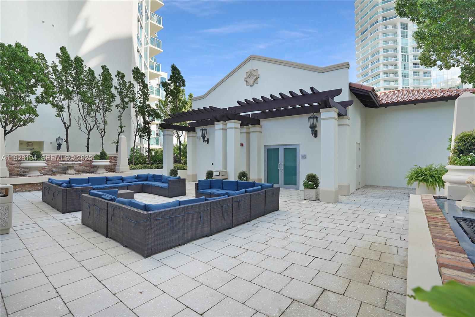 250 Sunny Isles Boulevard, Unit TH207 Sunny Isles Beach, FL 33160 - Photo 31 of 33 a view of a house with backyard and sitting area