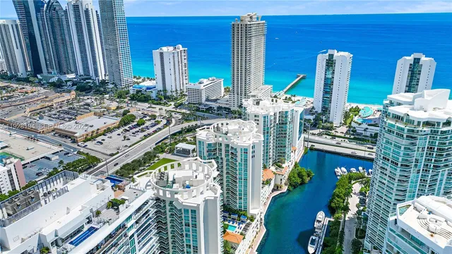 a balcony view with couple of chairs and potted plants