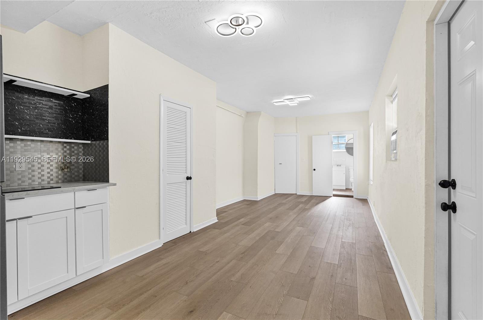 a view of hallway with wooden floor