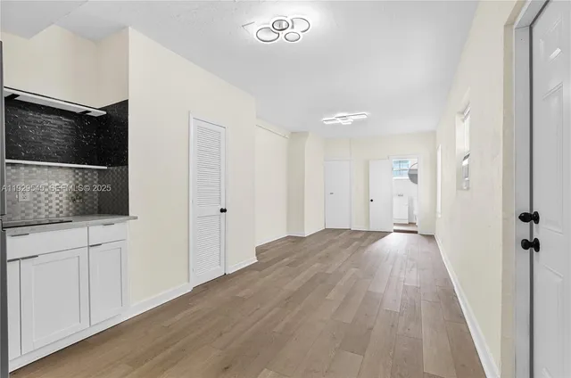 a view of hallway with wooden floor