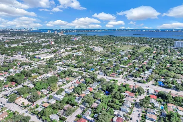an aerial view of residential houses with outdoor space and street view