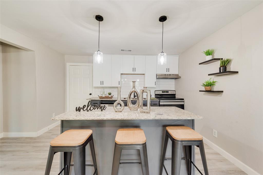109 Lydia Street Terrell, TX 75160 - Photo 12 of 24 a kitchen with stainless steel appliances granite countertop a sink a stove and chairs