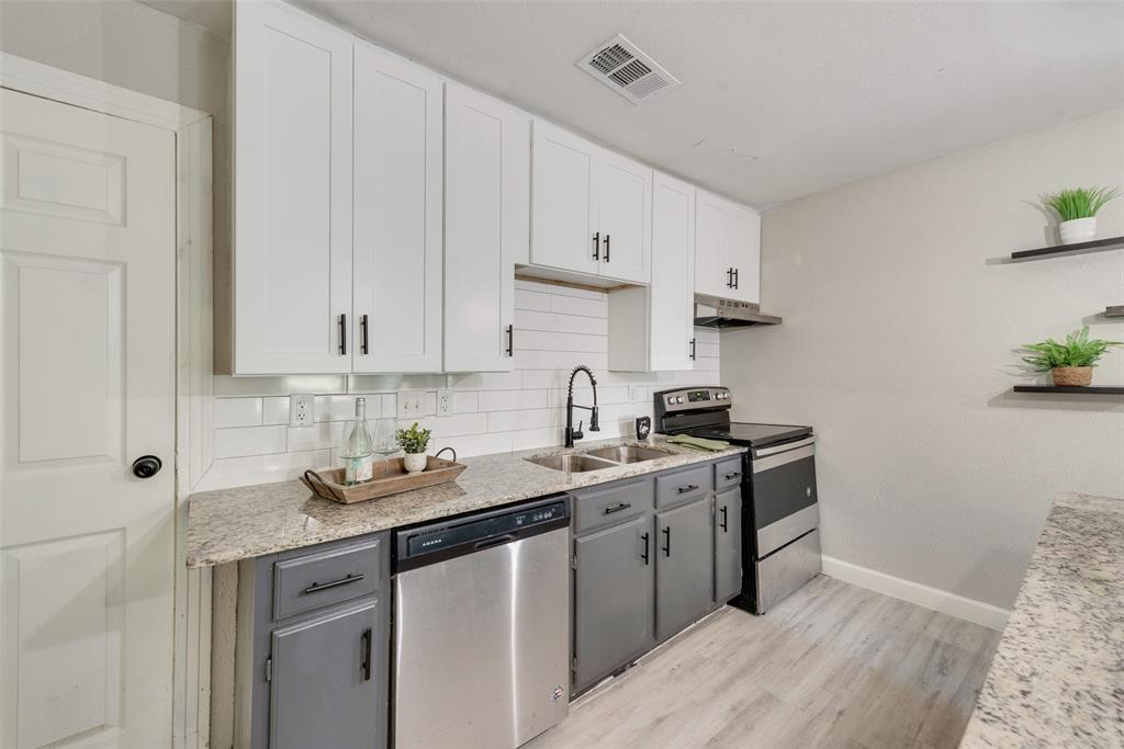 109 Lydia Street Terrell, TX 75160 - Photo 13 of 24 a kitchen with stainless steel appliances granite countertop a sink stove and cabinets
