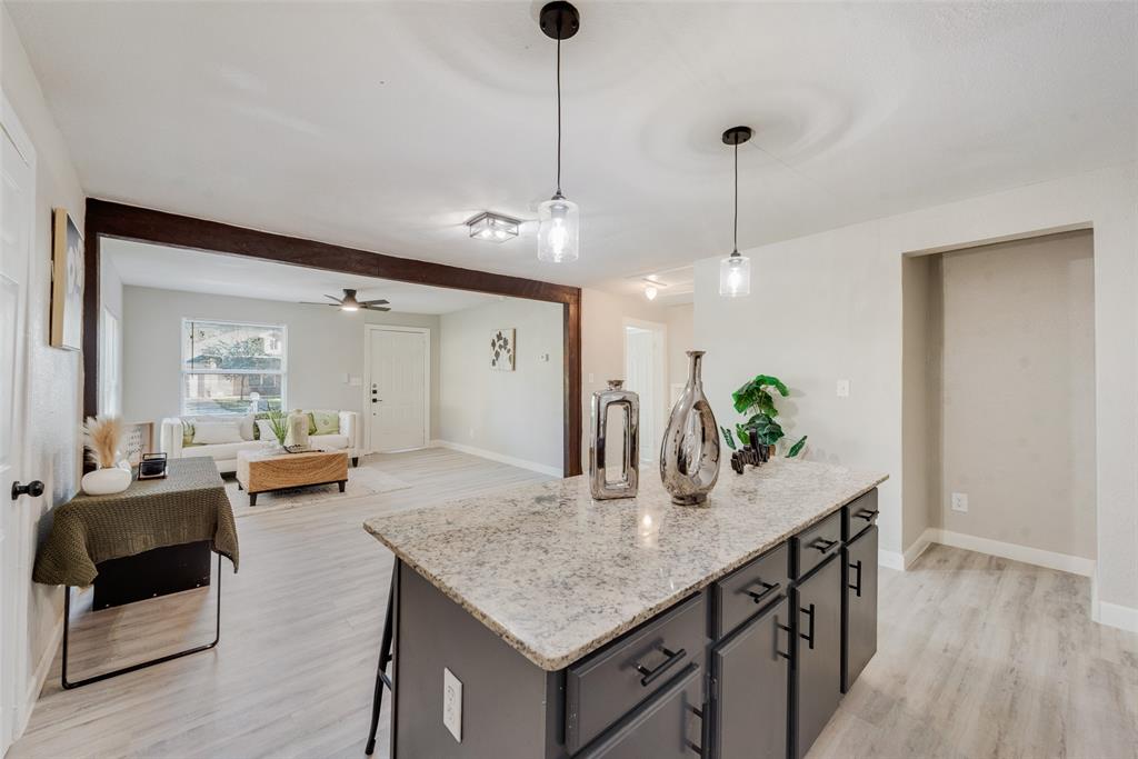 109 Lydia Street Terrell, TX 75160 - Photo 14 of 24 a living room with kitchen island furniture and a chandelier