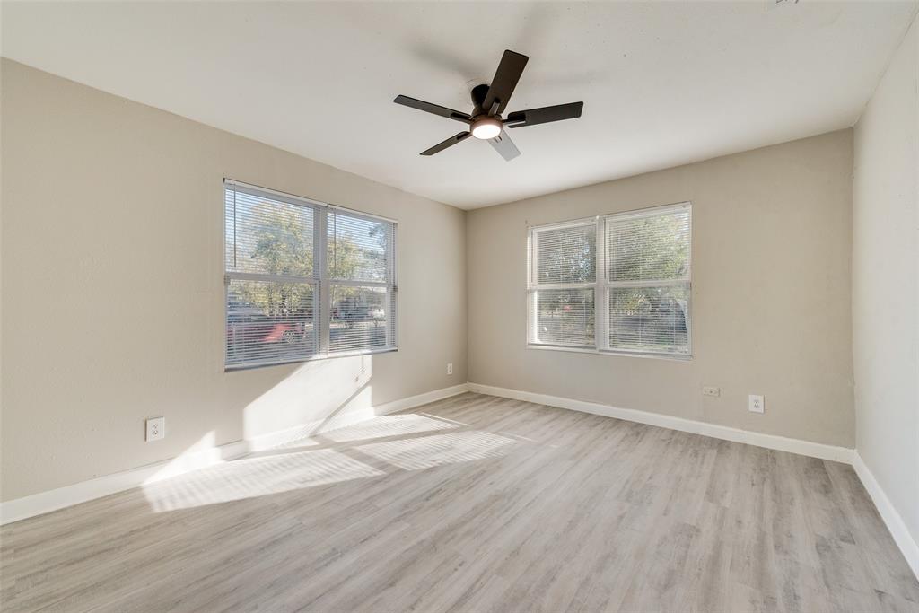 109 Lydia Street Terrell, TX 75160 - Photo 17 of 24 a view of an empty room with wooden floor and a window