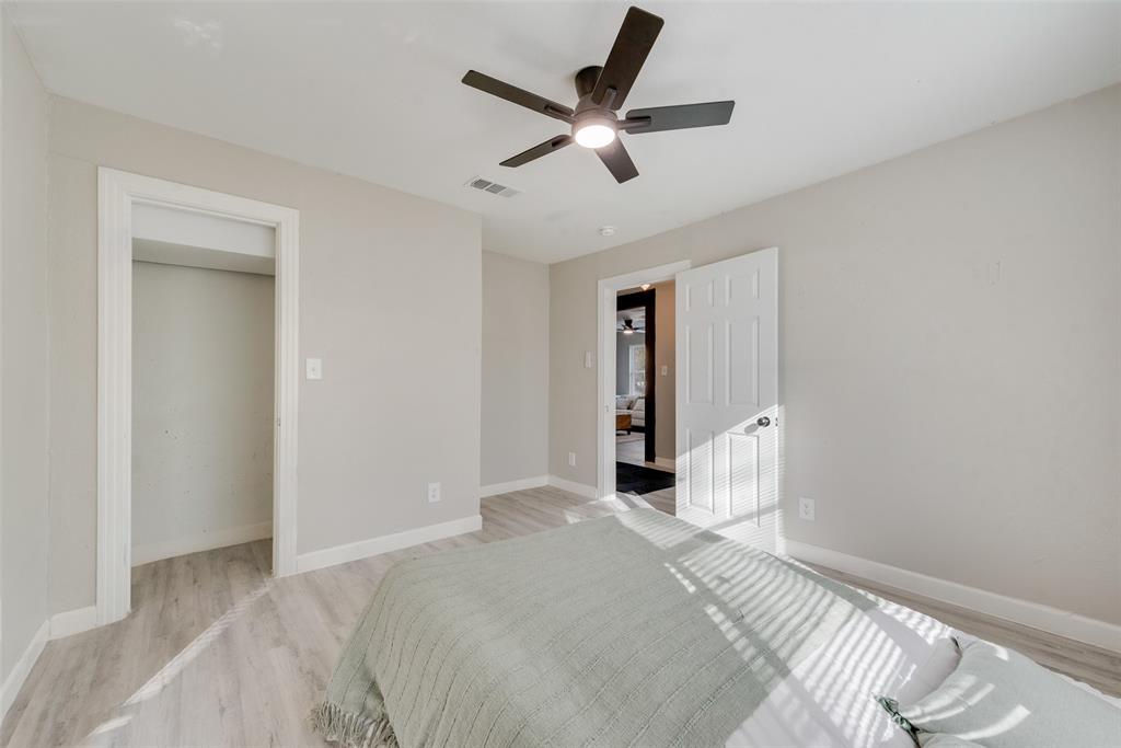 109 Lydia Street Terrell, TX 75160 - Photo 19 of 24 a bedroom with a large bed and a chandelier