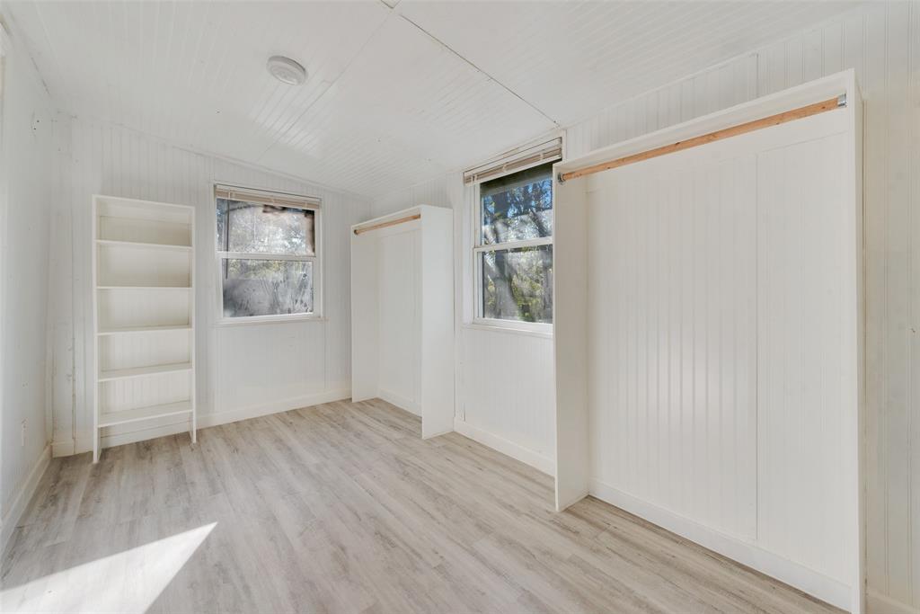 109 Lydia Street Terrell, TX 75160 - Photo 21 of 24 an empty room with wooden floor and windows