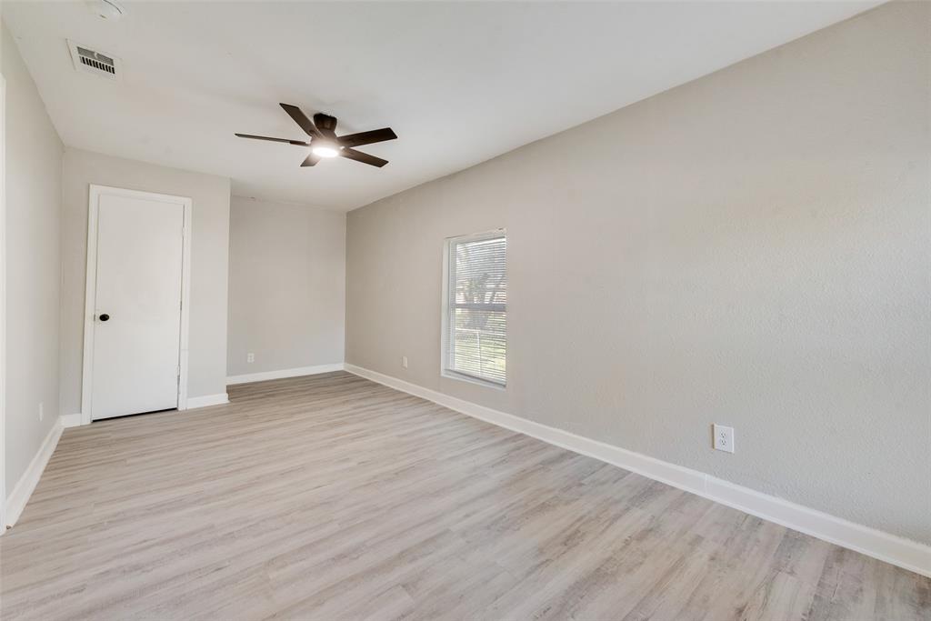 109 Lydia Street Terrell, TX 75160 - Photo 9 of 24 wooden floor in an empty room with a window