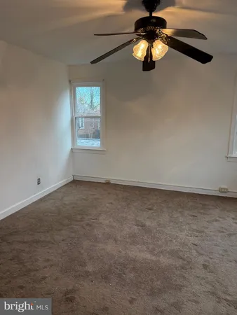 a view of a decorative ceiling fan in a room