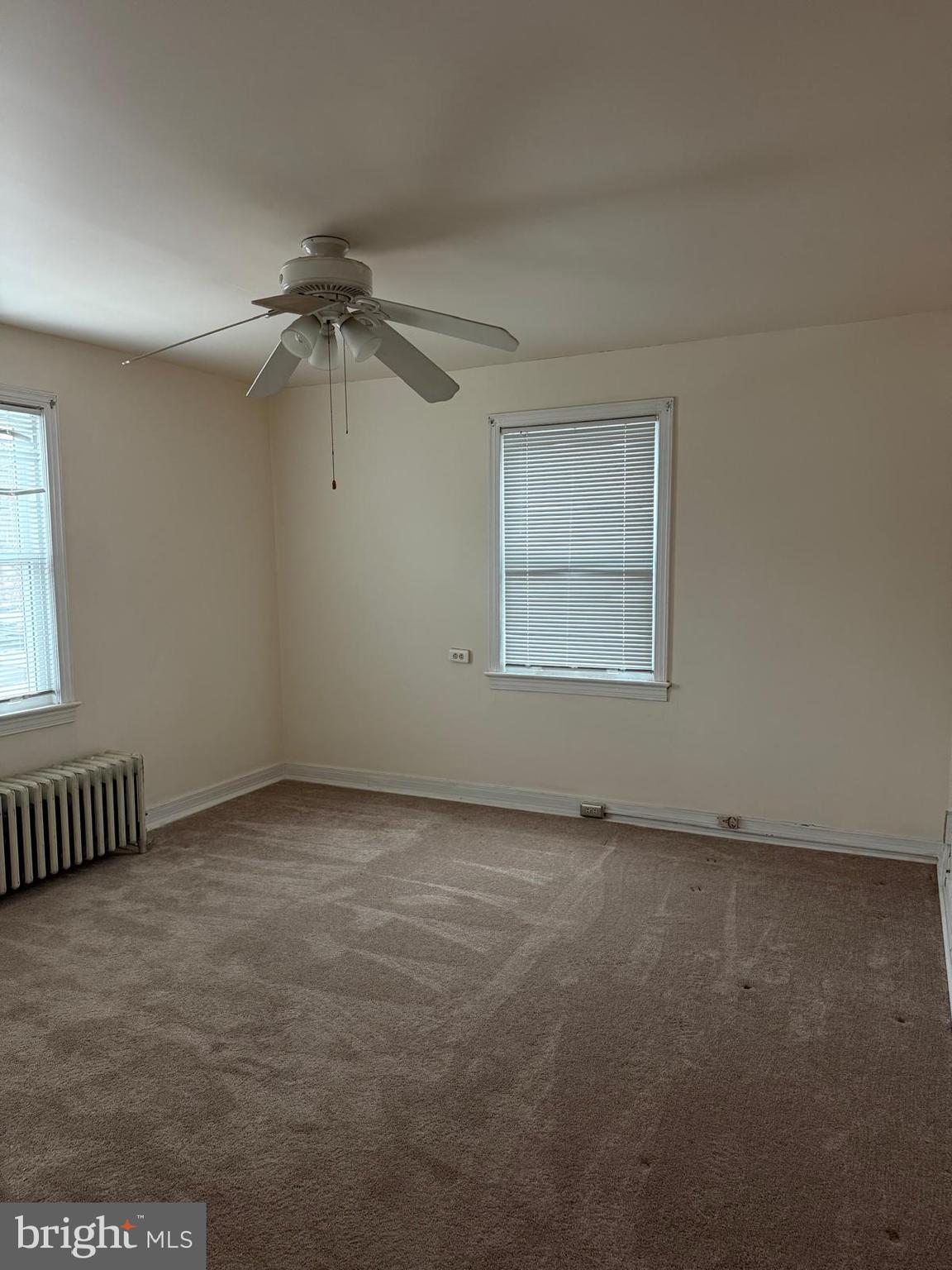 2211 32nd Place Southeast Washington, DC 20020 - Photo 18 of 24 an empty room with a ceiling fan and windows