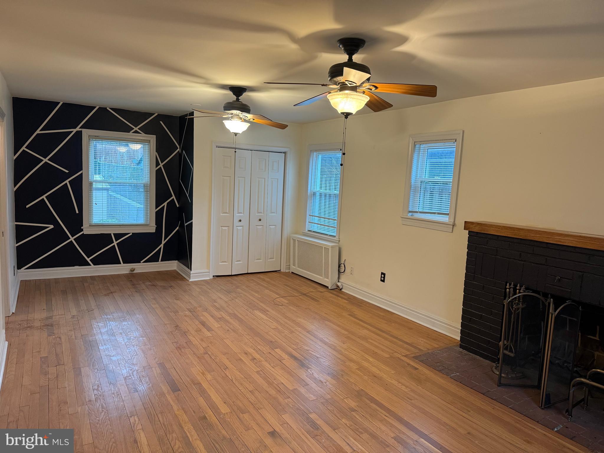 2211 32nd Place Southeast Washington, DC 20020 - Photo 22 of 24 a view of a livingroom with wooden floor and a ceiling fan
