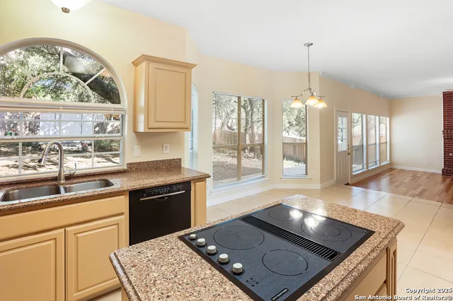 a kitchen with a sink stove and cabinets