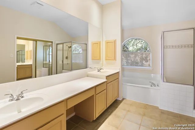 a bathroom with a tub sink and mirror