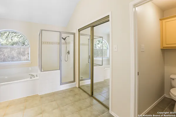 a view of a bathroom with bathtub and shower
