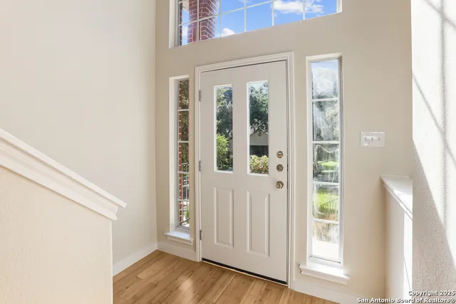 a view of front door with wooden floor