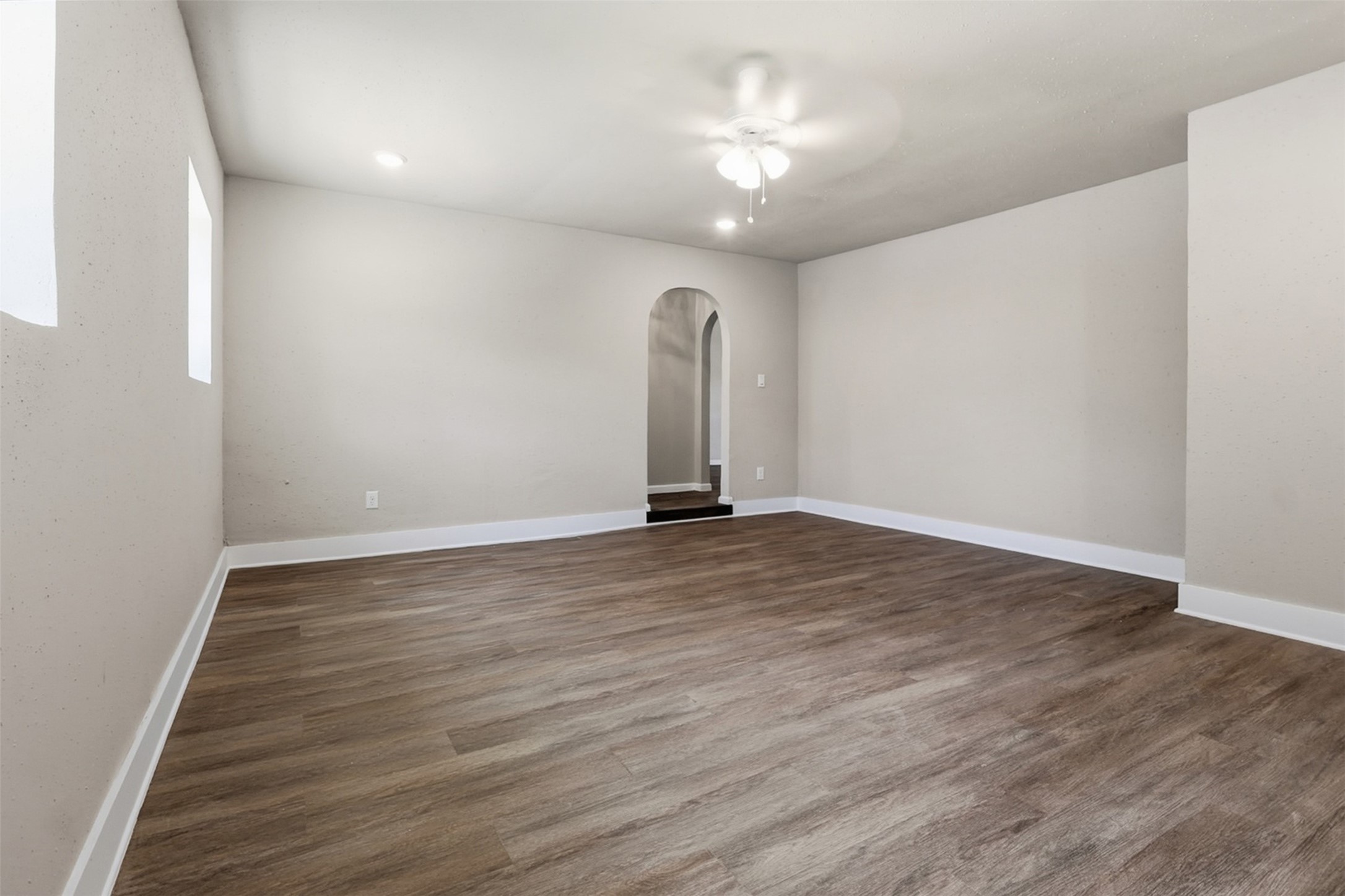 4767 Beechaven Street Houston, TX 77053 - Photo 14 of 26 an empty room with wooden floor and chandelier