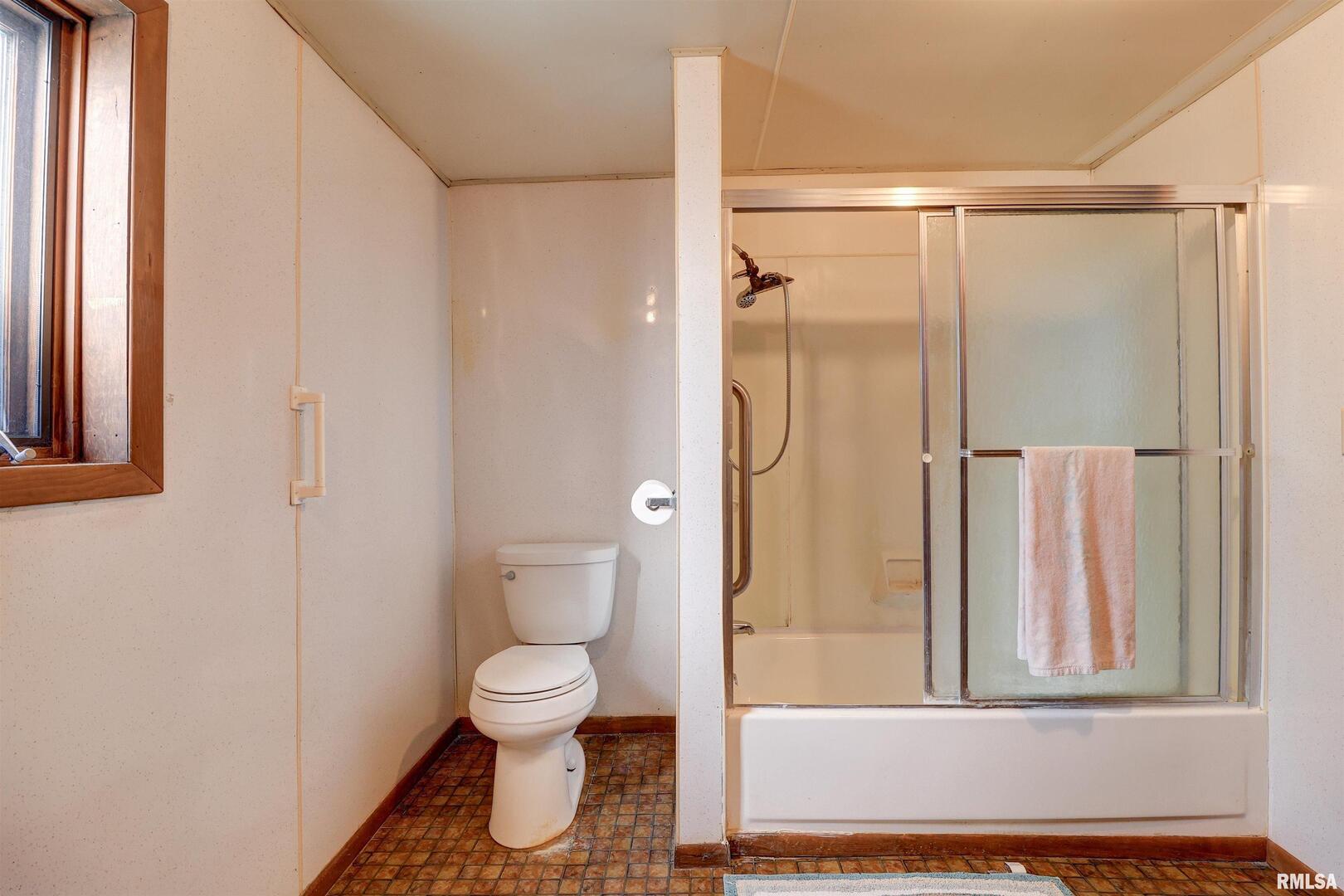 2002 Garfield Street Clinton, IA 52732 - Photo 12 of 19 a bathroom with a toilet and a shower