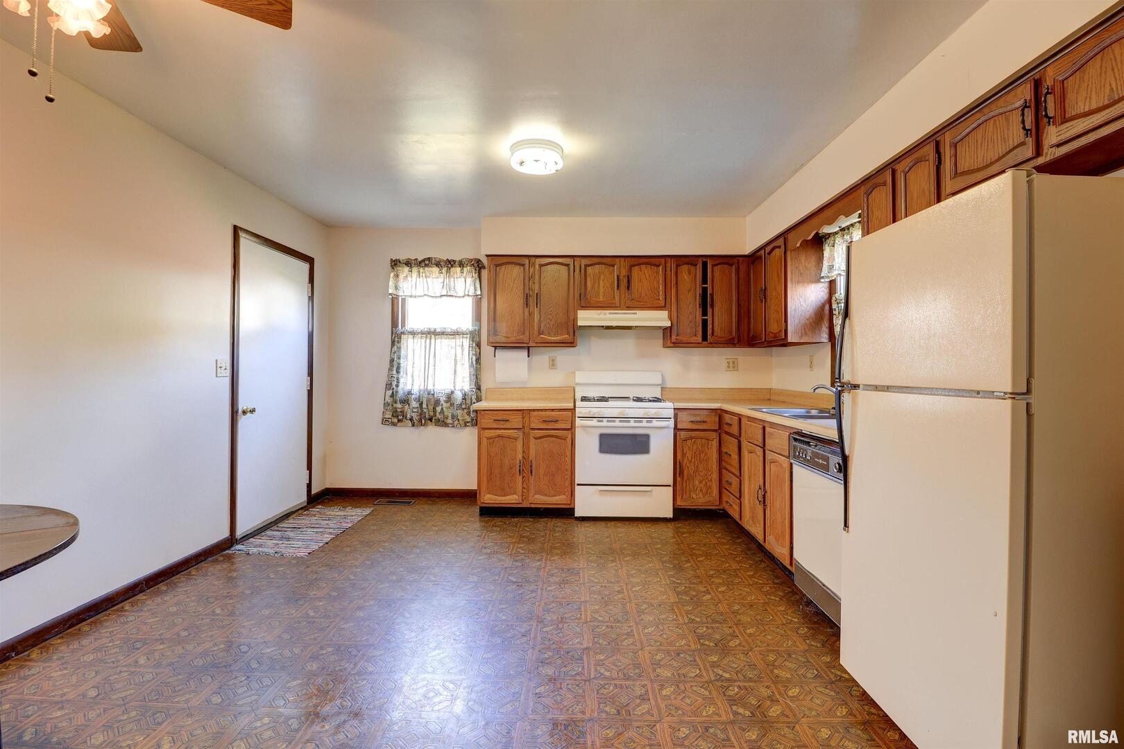 2002 Garfield Street Clinton, IA 52732 - Photo 6 of 19 a kitchen with a refrigerator and a stove