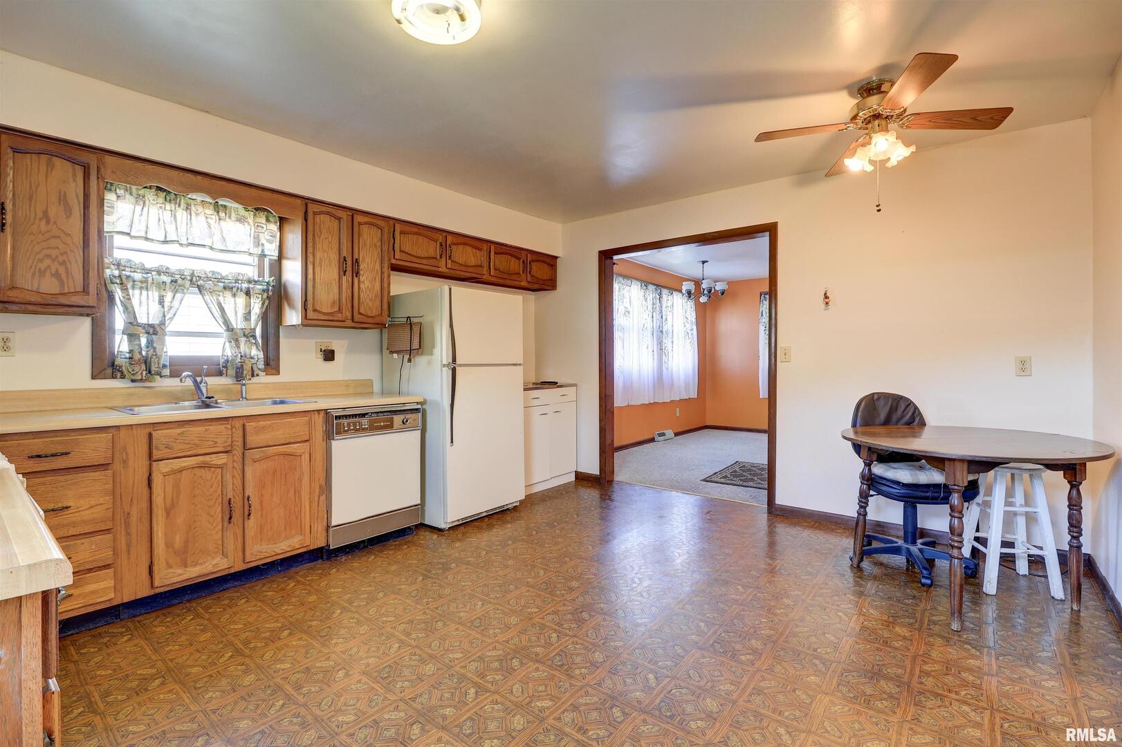 2002 Garfield Street Clinton, IA 52732 - Photo 7 of 19 a large white kitchen with cabinets