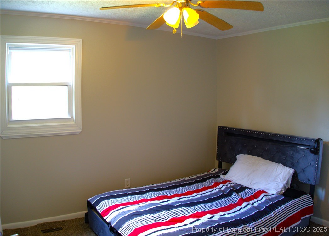 37 Jernigan Road Pembroke, NC 28372 - Photo 12 of 12 a bedroom with a bed and a lamp