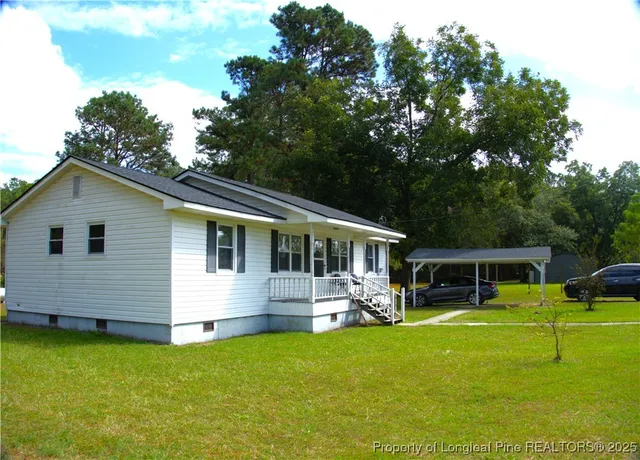 a front view of house with yard and swimming pool