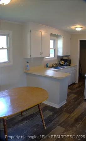 a room with wooden floor and cabinets