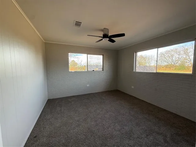 a view of an empty room with windows