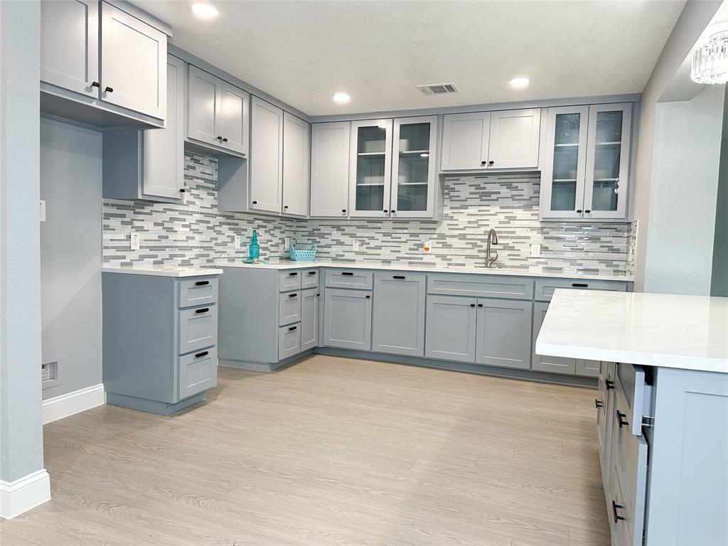 a kitchen with granite countertop a sink stainless steel appliances and cabinets