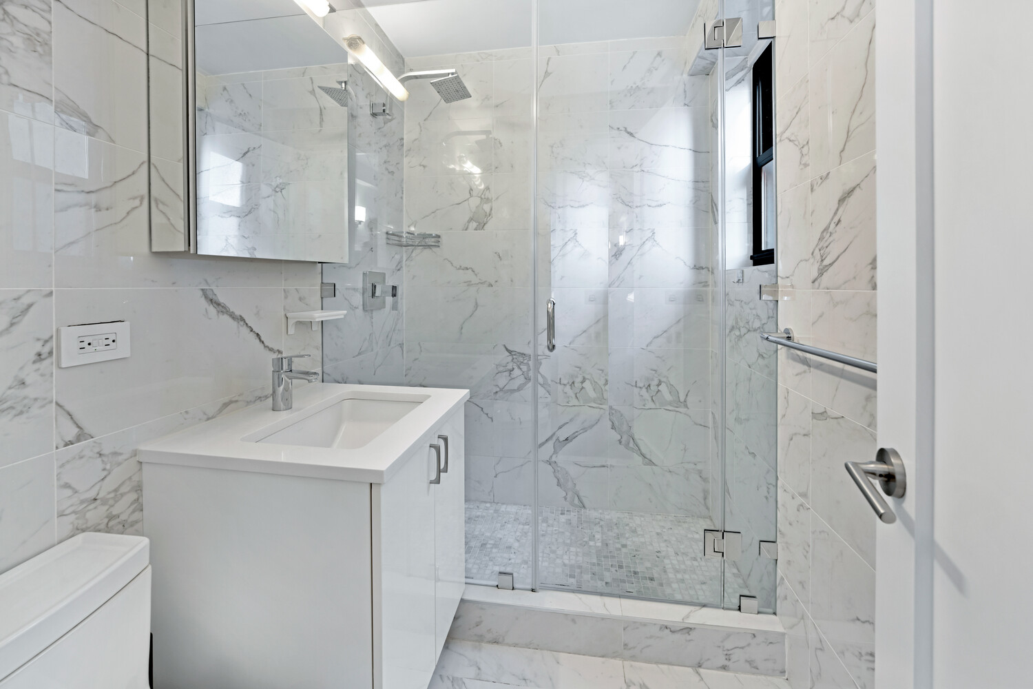196 East 75th Street, Unit 9A Manhattan, NY 10021 - Photo 6 of 10 a bathroom with a sink toilet and shower