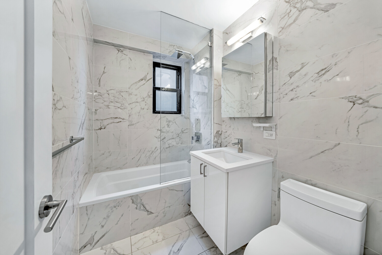 196 East 75th Street, Unit 9A Manhattan, NY 10021 - Photo 8 of 10 a bathroom with a sink toilet and shower