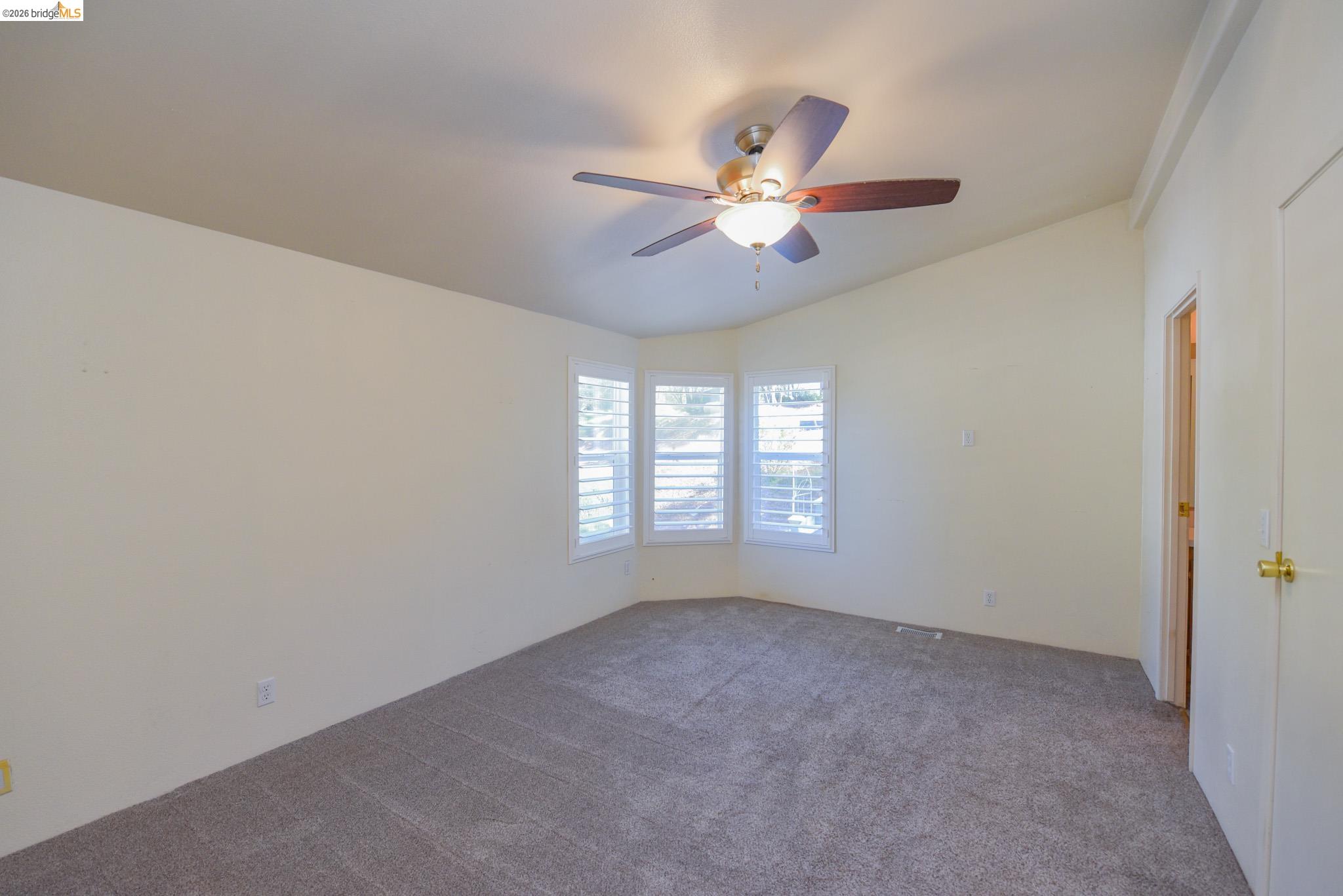 23732 Parrotts Ferry Road, Unit 47 Columbia, CA 95310 - Photo 13 of 21 Carpeted empty room with lofted ceiling and ceiling fan