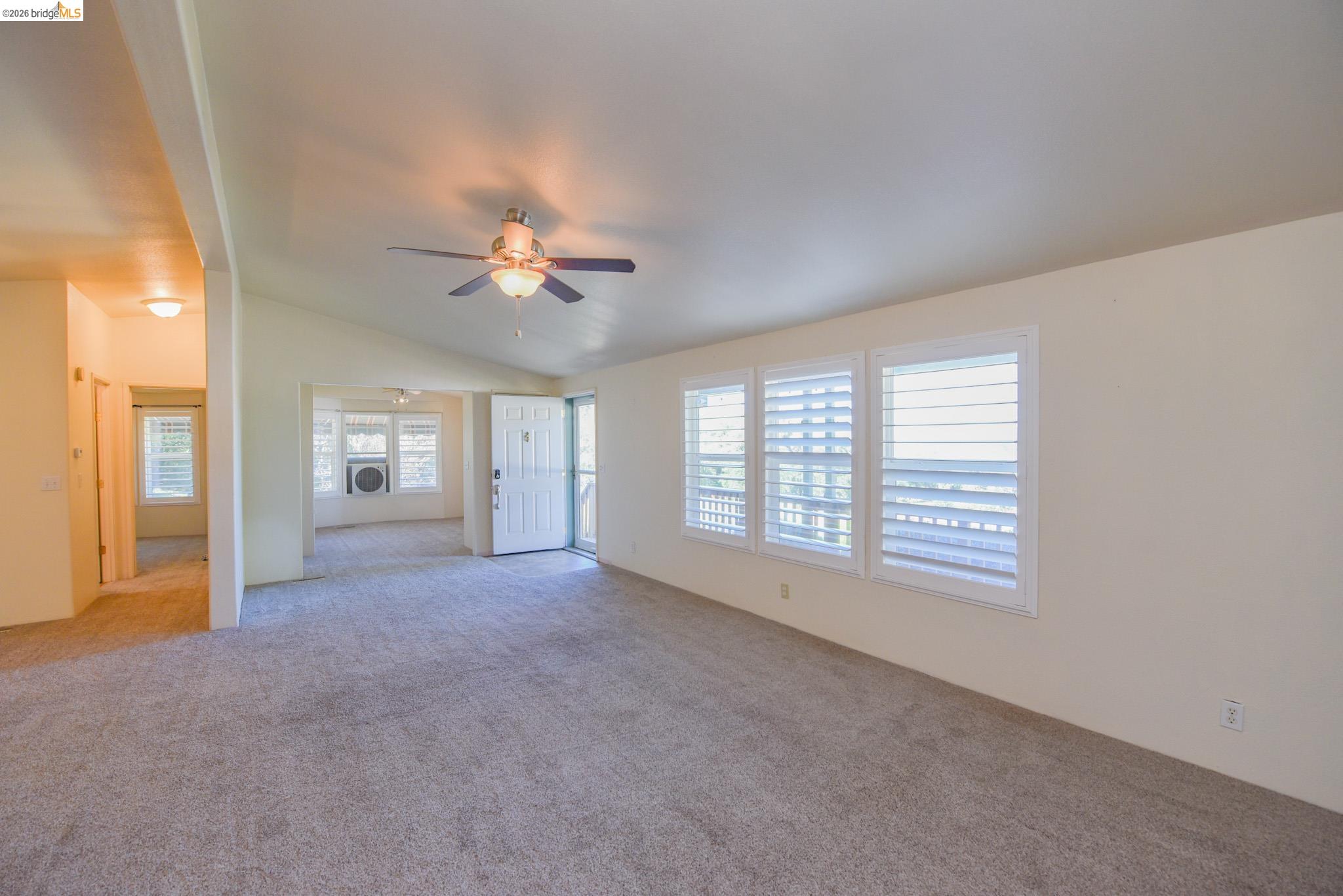 23732 Parrotts Ferry Road, Unit 47 Columbia, CA 95310 - Photo 8 of 21 Unfurnished living room with ceiling fan, light carpet, and lofted ceiling