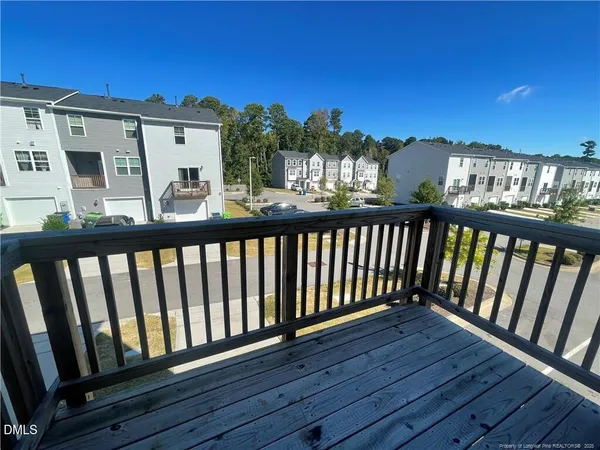 a view of a balcony with wooden floor and outdoor space