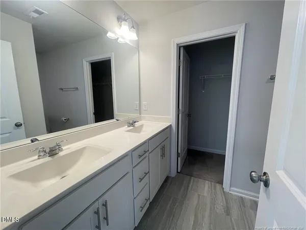 a bathroom with a double vanity sink and mirror