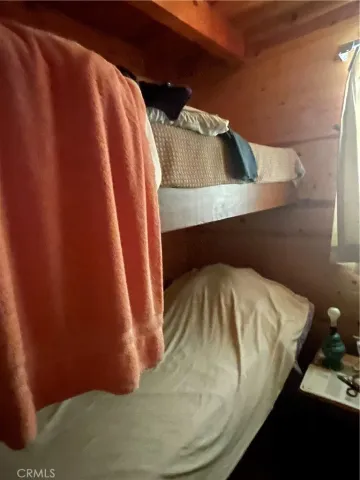 a kitchen with a sink a window and chairs