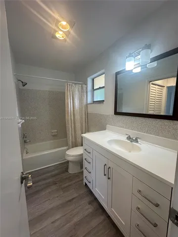 a bathroom with a double vanity sink toilet and shower