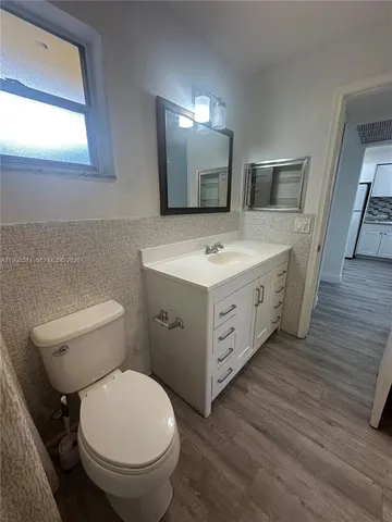 a spacious bathroom with a toilet sink and mirror