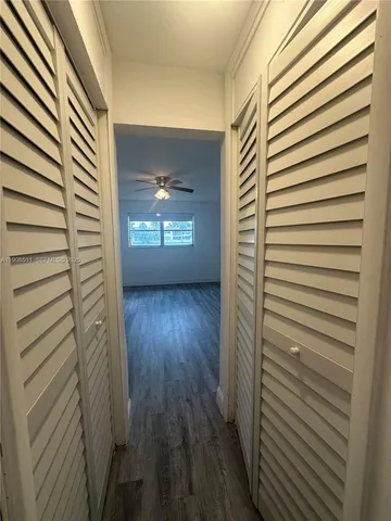 a view of hallway with wooden floor