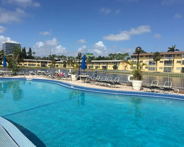 a view of swimming pool with outdoor seating and city view
