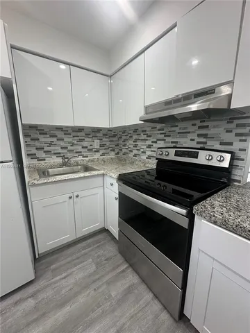 a kitchen with a stove and a sink