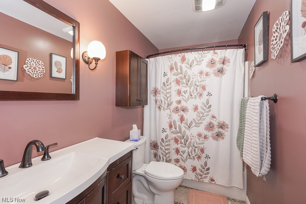1127 Garden Road Willoughby, OH 44094 - Photo 20 of 33 Bathroom featuring tile flooring, vanity with extensive cabinet space, and toilet