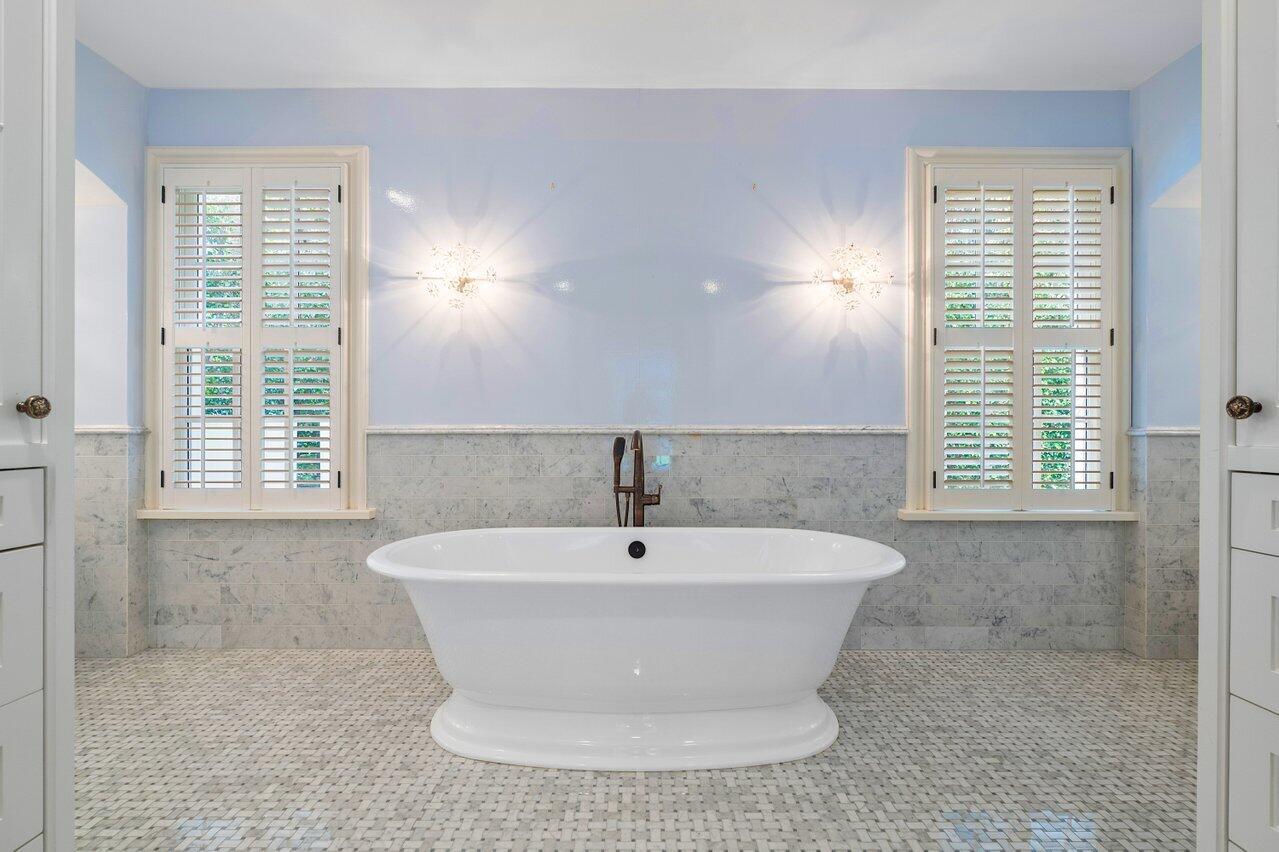 168 Kings Road Palm Beach, FL 33480 - Photo 29 of 49 a white bath tub sitting in a bathroom next to a window