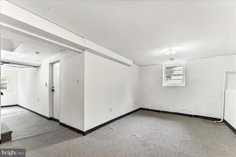 a white toilet sitting next to a window